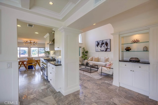 23851 Catamaran Way Unit 1, Laguna Niguel, CA 92677 - kitchen featuring stainless steel stove, dark countertops, crown molding, white cabinets, and a chandelier