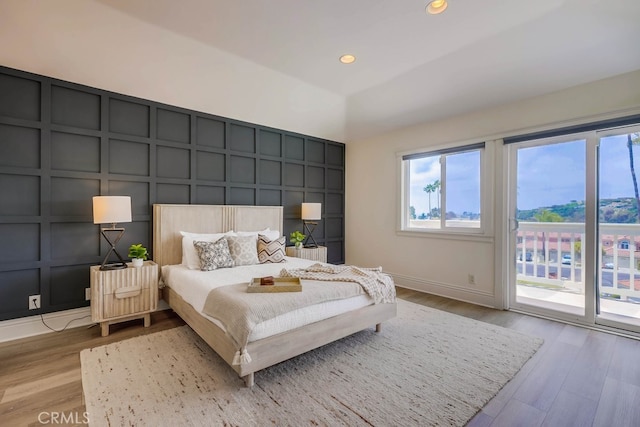 23851 Catamaran Way Unit 1, Laguna Niguel, CA 92677 - bedroom with a decorative wall, access to exterior, wood finished floors, and recessed lighting