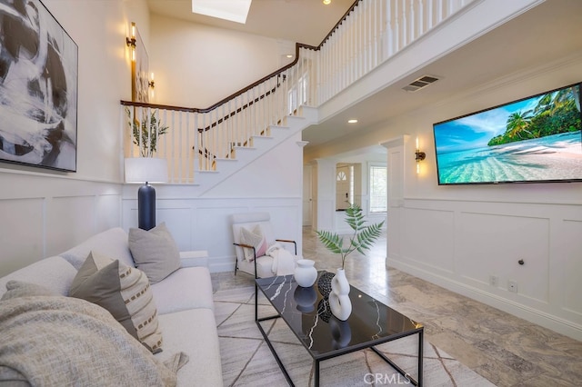23851 Catamaran Way Unit 1, Laguna Niguel, CA 92677 - living area featuring a decorative wall, recessed lighting, a high ceiling, stairway, and a wainscoted wall