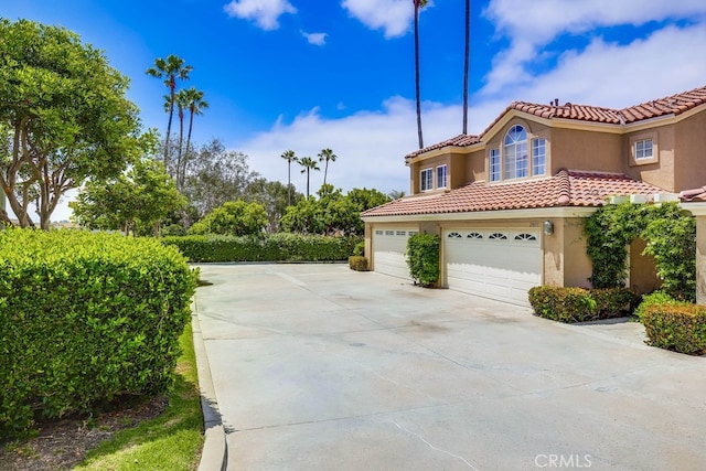 23851 Catamaran Way Unit 1, Laguna Niguel, CA 92677 - view of property exterior with a tile roof, stucco siding, concrete driveway, and an attached garage