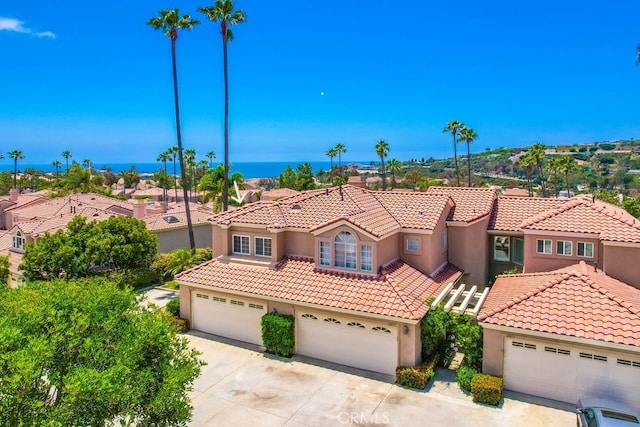 23851 Catamaran Way Unit 1, Laguna Niguel, CA 92677 - mediterranean / spanish-style home with stucco siding, a tiled roof, concrete driveway, and a residential view