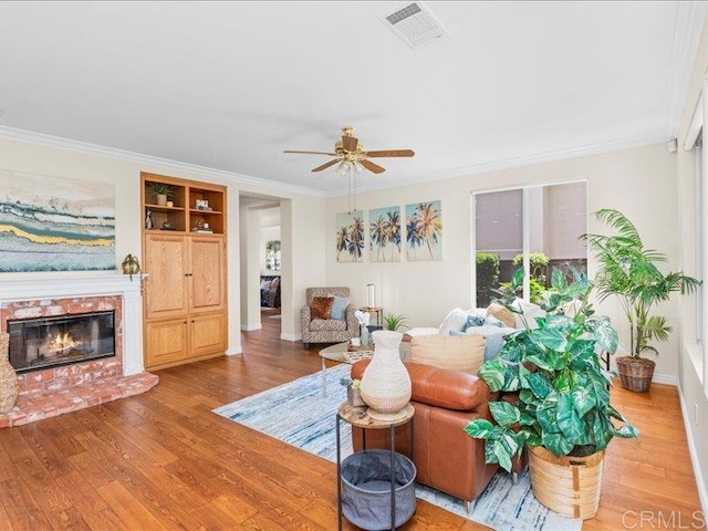 2381 Avenida Helecho, Carlsbad, CA 92009 - living room featuring ornamental molding, a ceiling fan, light wood finished floors, and a brick fireplace