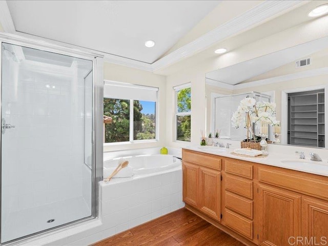 2381 Avenida Helecho, Carlsbad, CA 92009 - bathroom with vaulted ceiling, wood finished floors, a shower stall, double vanity, and a garden tub