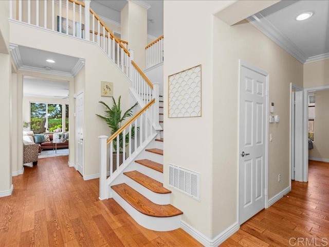 2381 Avenida Helecho, Carlsbad, CA 92009 - staircase with crown molding and wood-type flooring
