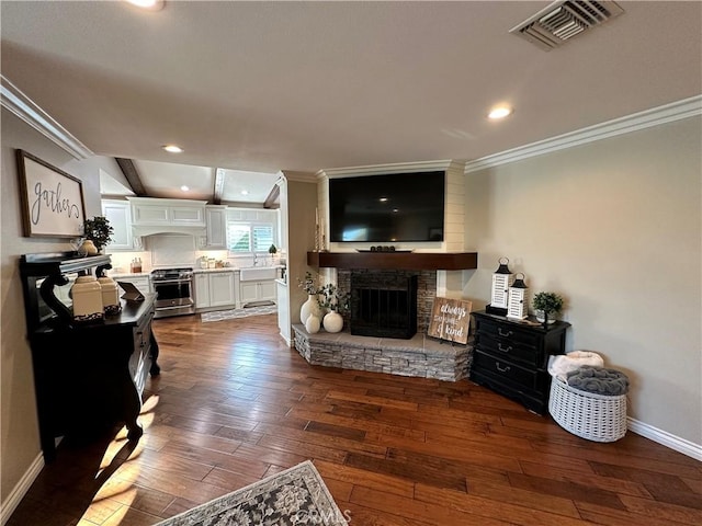 832 Prima Vera Rd, Glendora, CA 91741 - living area with crown molding, dark wood-style floors, a stone fireplace, and recessed lighting