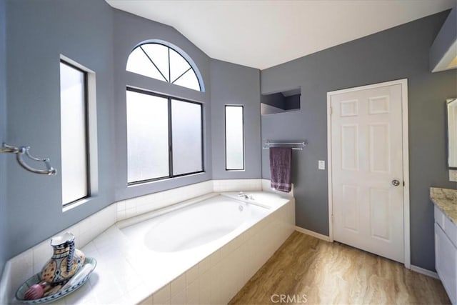 5963 Rio Valle Dr, Bonsall, CA 92003 - full bathroom featuring vanity, healthy amount of natural light, vaulted ceiling, and a bath
