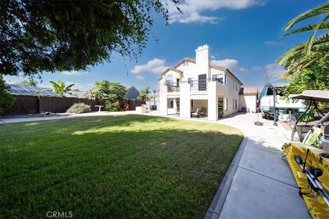 5963 Rio Valle Dr, Bonsall, CA 92003 - back of property featuring a balcony, a fenced backyard, a patio area, stucco siding, and a chimney
