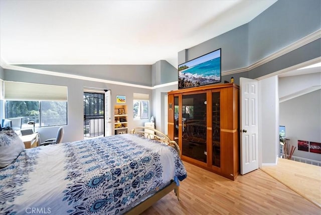 5963 Rio Valle Dr, Bonsall, CA 92003 - bedroom featuring lofted ceiling, multiple windows, wood finished floors, and access to exterior