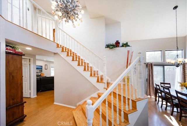 5963 Rio Valle Dr, Bonsall, CA 92003 - staircase with a chandelier, wood finished floors, and a towering ceiling