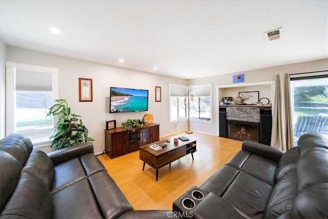 5963 Rio Valle Dr, Bonsall, CA 92003 - living room featuring light wood finished floors, recessed lighting, and a lit fireplace