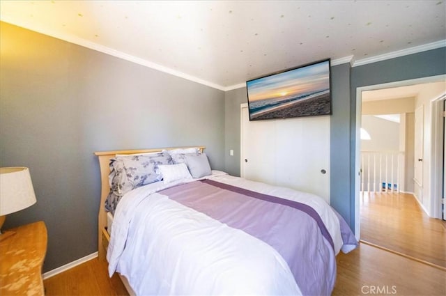 5963 Rio Valle Dr, Bonsall, CA 92003 - bedroom with wood finished floors, ornamental molding, and a closet