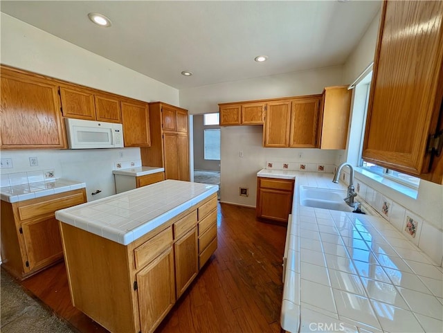 9510 Nickellaus Ct, Corona, CA 92883 - kitchen with white microwave, tile countertops, brown cabinets, dark wood-type flooring, and recessed lighting