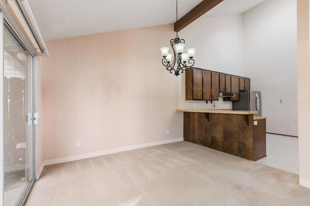 6767 Camino Del Prado, Carlsbad, CA 92011 - unfurnished dining area featuring a chandelier, light colored carpet, beam ceiling, and high vaulted ceiling