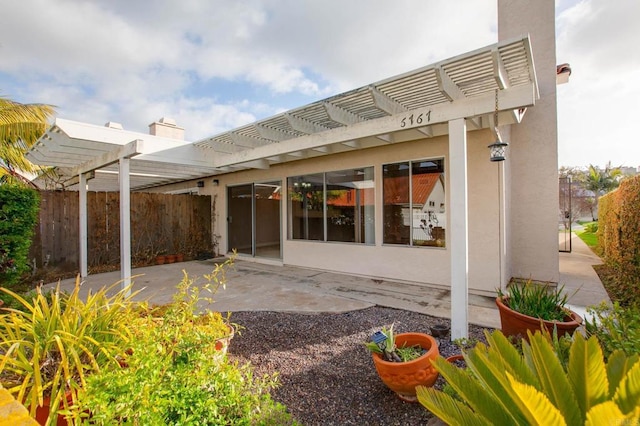 6767 Camino Del Prado, Carlsbad, CA 92011 - rear view of house with a pergola, a patio area, and stucco siding