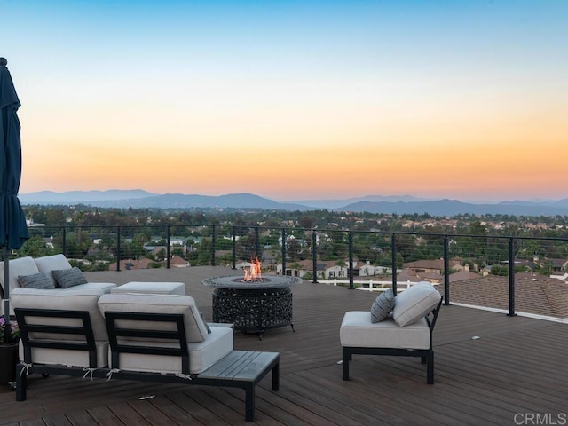31755 Rancho Vista Rd, Temecula, CA 92592 - deck at dusk featuring a mountain view and an outdoor living space with a fire pit