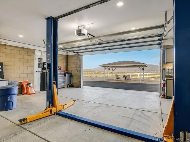 31755 Rancho Vista Rd, Temecula, CA 92592 - garage featuring a garage door opener and concrete block wall