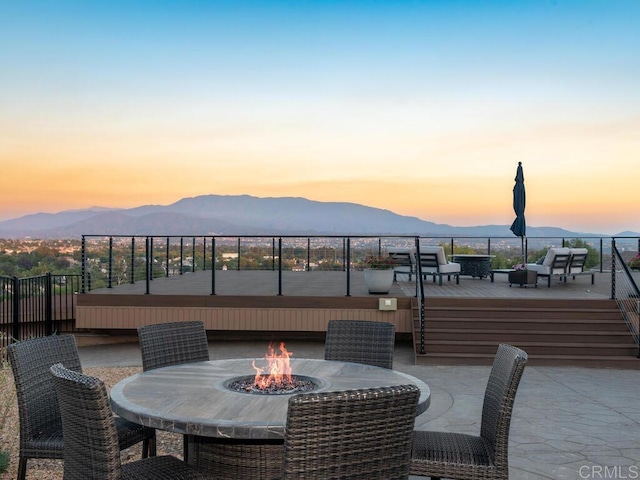 31755 Rancho Vista Rd, Temecula, CA 92592 - patio terrace at dusk featuring a fire pit and a deck with mountain view