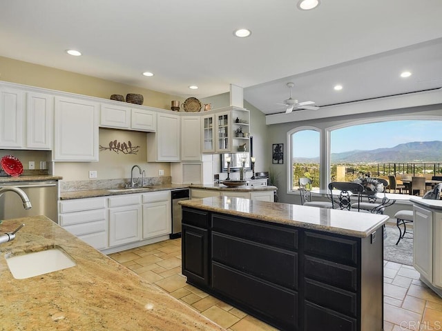 31755 Rancho Vista Rd, Temecula, CA 92592 - kitchen with white cabinetry, dark cabinetry, recessed lighting, light stone countertops, and dishwasher