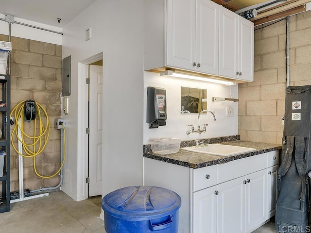 31755 Rancho Vista Rd, Temecula, CA 92592 - kitchen featuring white cabinets, dark countertops, concrete floors, and electric panel
