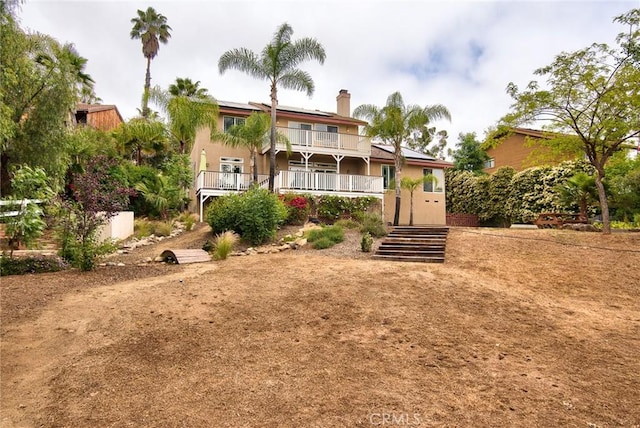 25919 Matlin Rd, Ramona, CA 92065 - view of front of property with roof mounted solar panels, stairs, a chimney, and a balcony