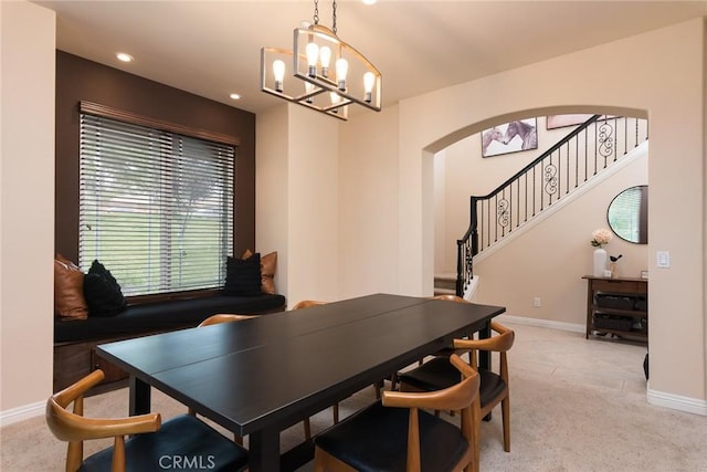 25919 Matlin Rd, Ramona, CA 92065 - dining space with arched walkways, a chandelier, light colored carpet, stairway, and recessed lighting