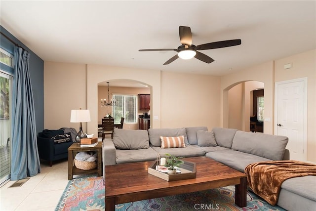 25919 Matlin Rd, Ramona, CA 92065 - living room with arched walkways, ceiling fan, a chandelier, and light tile patterned flooring