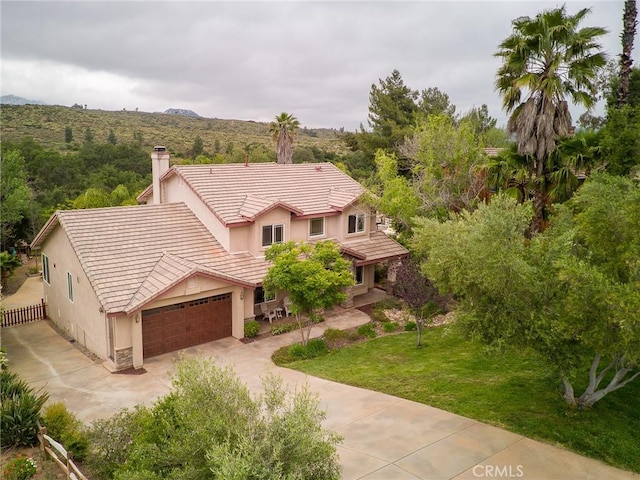 25919 Matlin Rd, Ramona, CA 92065 - view of front of house with a chimney, driveway, a tile roof, stucco siding, and an attached garage