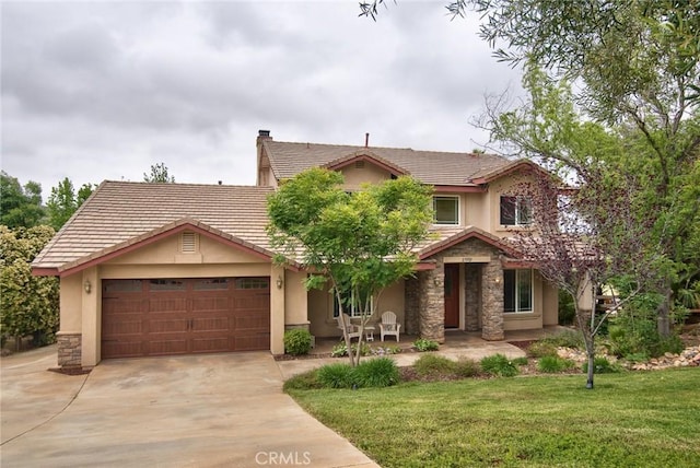 25919 Matlin Rd, Ramona, CA 92065 - view of front facade with stucco siding, stone siding, a garage, concrete driveway, and a front lawn