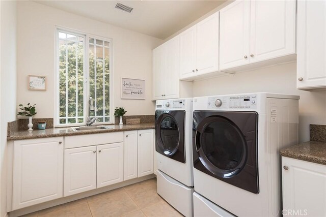 25919 Matlin Rd, Ramona, CA 92065 - laundry area featuring washer and dryer, cabinet space, and light tile patterned floors