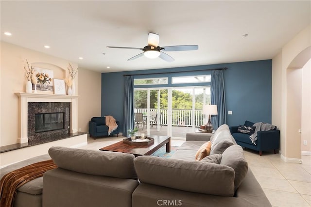 25919 Matlin Rd, Ramona, CA 92065 - living room featuring light tile patterned floors, arched walkways, recessed lighting, a premium fireplace, and a ceiling fan