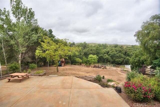 25919 Matlin Rd, Ramona, CA 92065 - view of patio / terrace featuring a playground and a wooded view