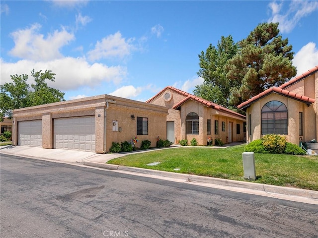 19128 Cedar Dr, Apple Valley, CA 92308 - mediterranean / spanish-style home with an attached garage, a front lawn, driveway, and stucco siding