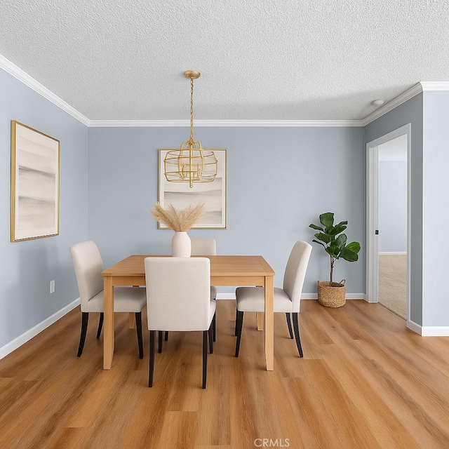 19128 Cedar Dr, Apple Valley, CA 92308 - dining space featuring a chandelier, light wood-type flooring, a textured ceiling, and ornamental molding