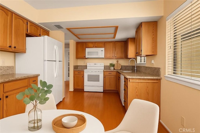 19128 Cedar Dr, Apple Valley, CA 92308 - kitchen with white appliances, dark wood-style floors, and brown cabinetry