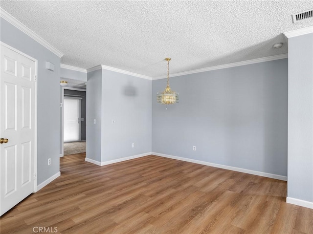 19128 Cedar Dr, Apple Valley, CA 92308 - unfurnished room with light wood-type flooring, a smoke detector, a textured ceiling, and crown molding