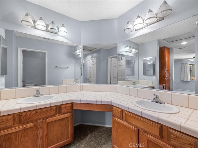 19128 Cedar Dr, Apple Valley, CA 92308 - bathroom featuring double vanity and a textured ceiling
