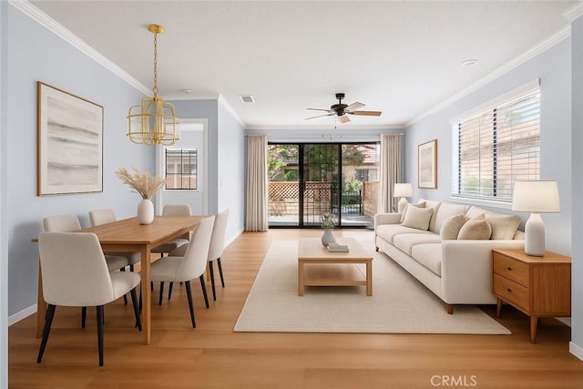 19128 Cedar Dr, Apple Valley, CA 92308 - living room featuring crown molding, a chandelier, light wood-style flooring, and ceiling fan