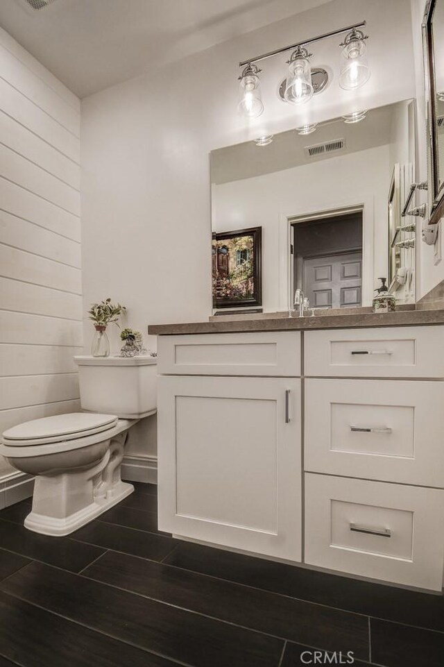 5101 Caspian Cir, Huntington Beach, CA 92649 - bathroom with vanity, wood finished floors, and wooden walls