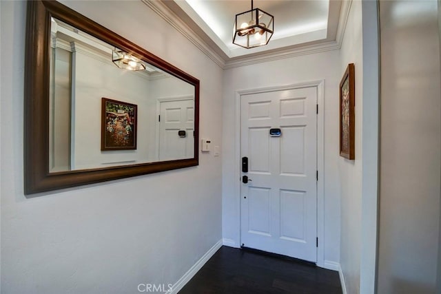 5101 Caspian Cir, Huntington Beach, CA 92649 - foyer entrance with a chandelier, dark wood finished floors, crown molding, and a raised ceiling