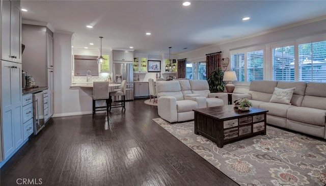 5101 Caspian Cir, Huntington Beach, CA 92649 - living room with ornamental molding, dark wood-style flooring, recessed lighting, and beverage cooler