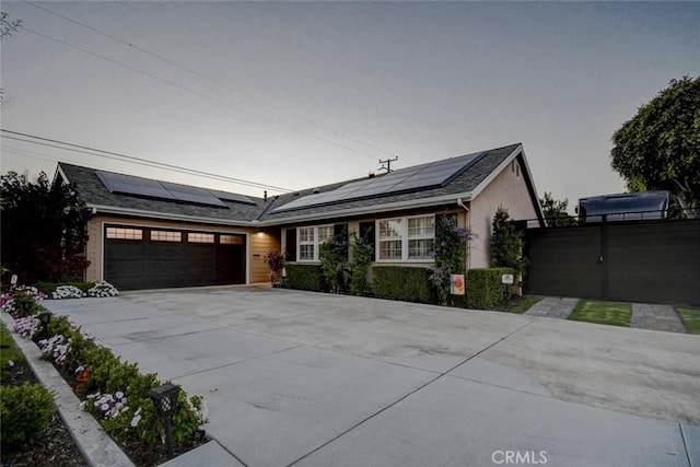 5101 Caspian Cir, Huntington Beach, CA 92649 - ranch-style home with driveway, a garage, and solar panels