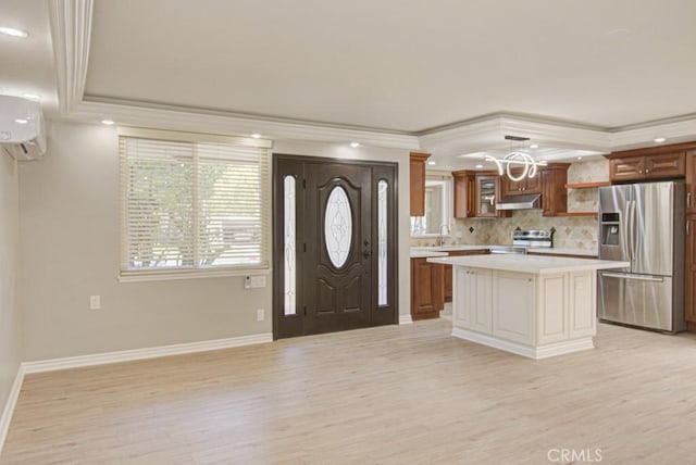767 Calle Aragon Unit A, Laguna Woods, CA 92637 - foyer featuring light wood-style floors, a wall unit AC, crown molding, recessed lighting, and a chandelier