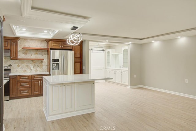 767 Calle Aragon Unit A, Laguna Woods, CA 92637 - kitchen featuring stainless steel appliances, light wood-style flooring, light countertops, crown molding, and decorative backsplash