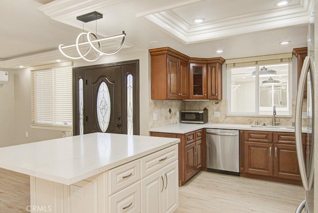 767 Calle Aragon Unit A, Laguna Woods, CA 92637 - kitchen with appliances with stainless steel finishes, crown molding, a tray ceiling, decorative backsplash, and brown cabinets
