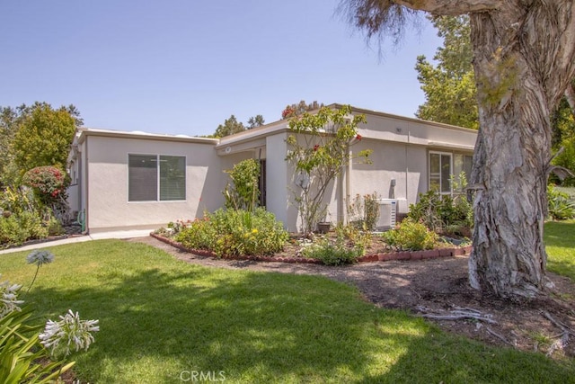 767 Calle Aragon Unit A, Laguna Woods, CA 92637 - view of side of property with a yard and stucco siding