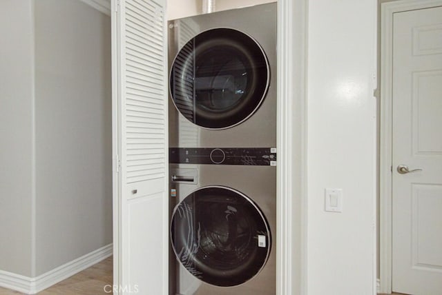 767 Calle Aragon Unit A, Laguna Woods, CA 92637 - washroom featuring estacked washer and dryer and baseboards