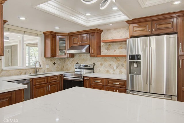 767 Calle Aragon Unit A, Laguna Woods, CA 92637 - kitchen with stainless steel appliances, under cabinet range hood, ornamental molding, a raised ceiling, and decorative backsplash