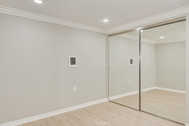 767 Calle Aragon Unit A, Laguna Woods, CA 92637 - unfurnished bedroom with wood finished floors, a closet, recessed lighting, and ornamental molding