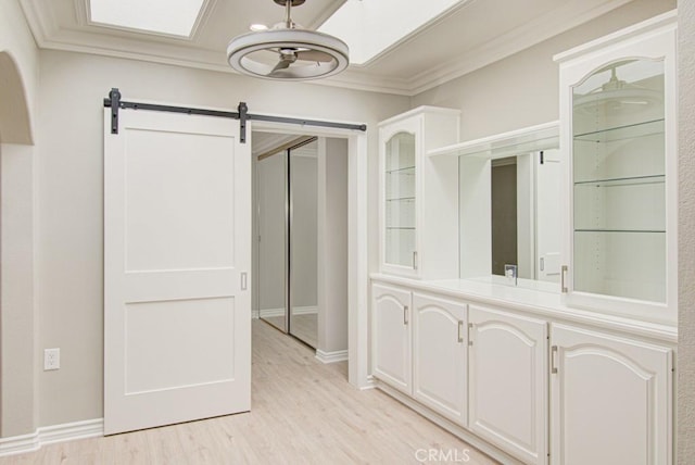 767 Calle Aragon Unit A, Laguna Woods, CA 92637 - hall with light wood-style floors, ornamental molding, and a barn door