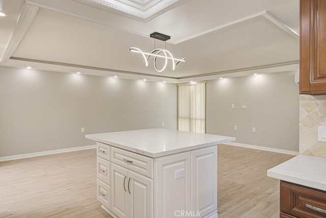 767 Calle Aragon Unit A, Laguna Woods, CA 92637 - kitchen with light wood-style floors, a kitchen island, white cabinets, pendant lighting, and open floor plan